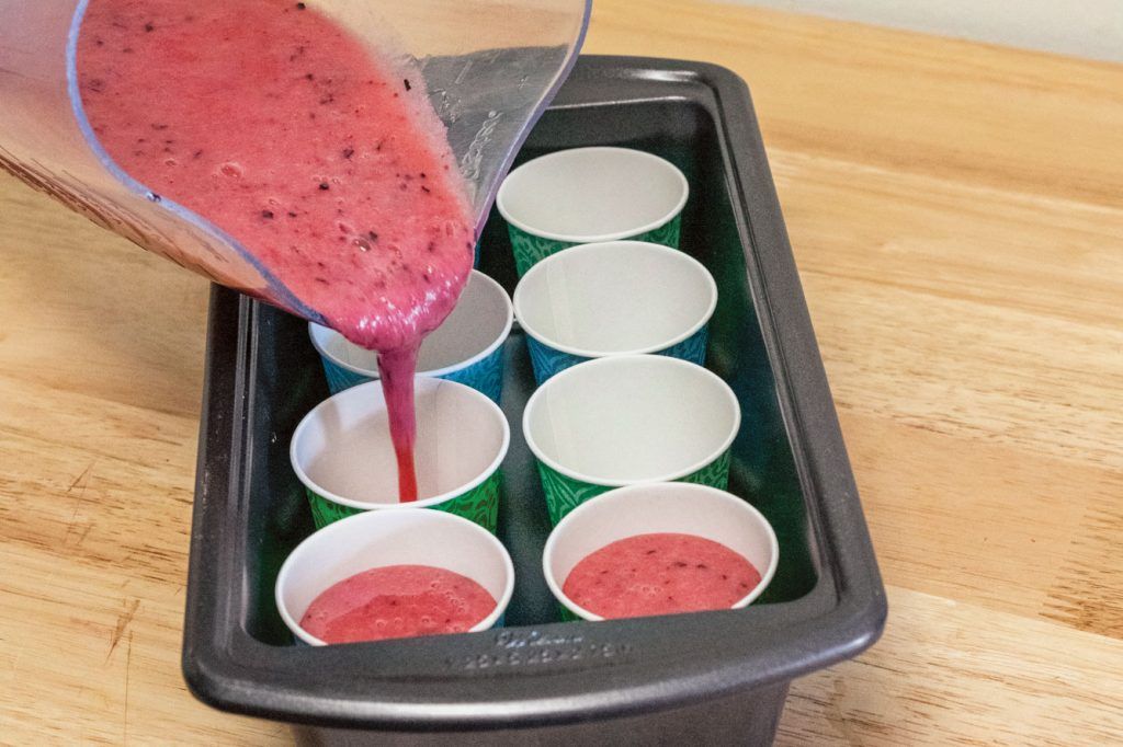 how to make planet-friendly ice lollies: the mixture is poured into paper cups from a jug