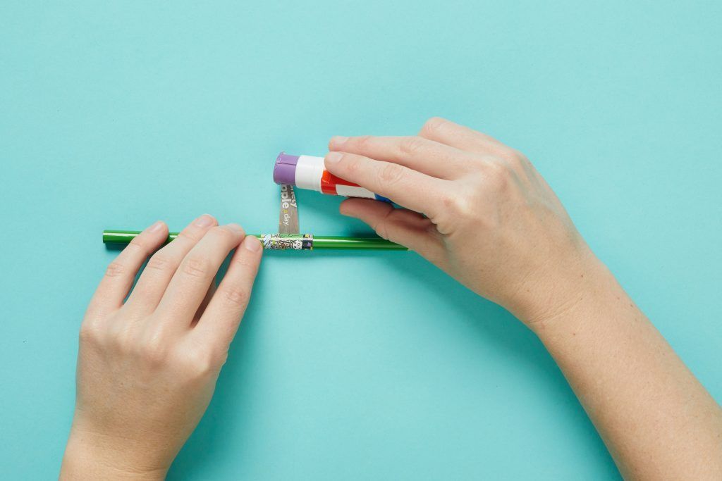 Tightly rolling paper onto the pencil