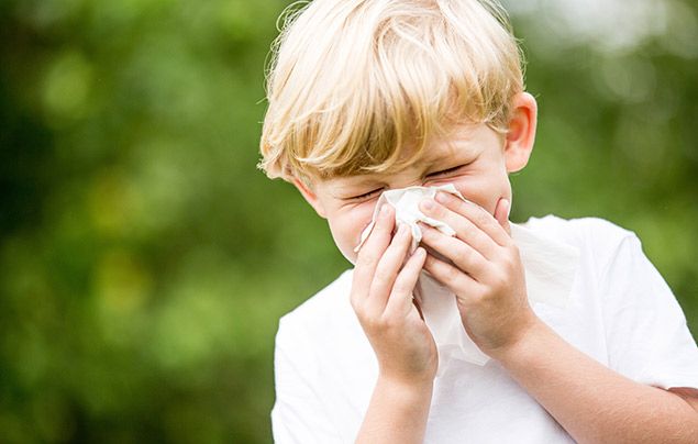 What is coronavirus: boy sneezing into tissue