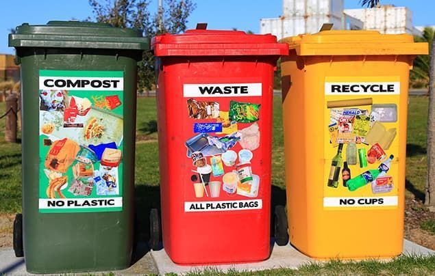 how to save the planet | three big bins sit alongside eachother. one green one is for compost, one red one for waste, and a yellow one for recycling