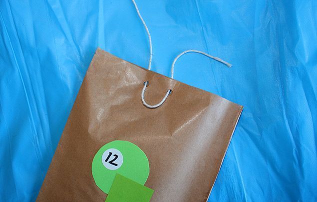 how to make an advent calendar | punch holes in the bags and thread string through
