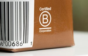 a B corp label on a package. The label has a capital B in a white circle, and says 'certified'.