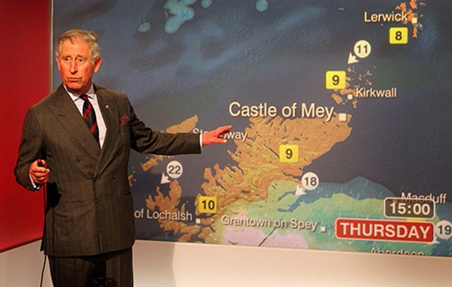 Charles stands in front of a large weather map, earnestly speaking to camera