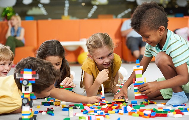 a group of kids playing with blocks