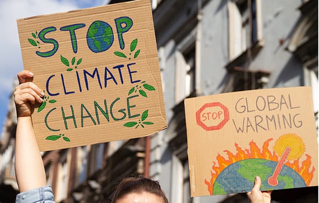 sdgs | people hold up signs at a climate change protest