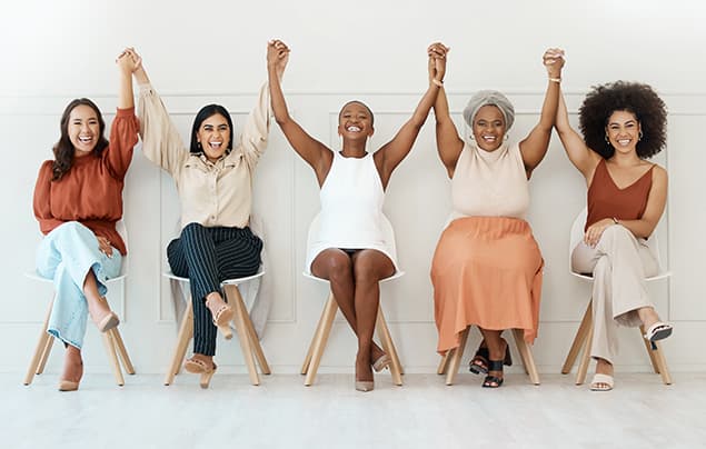 sdgs | a group of women raise up their held hands