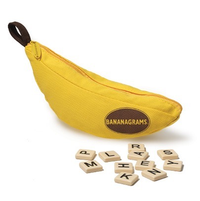A yellow, banana-shaped zippered pouch labeled Bananagrams lies next to scattered letter tiles, perfect for fans of fast-paced word games like Dobble and Bananagrams.