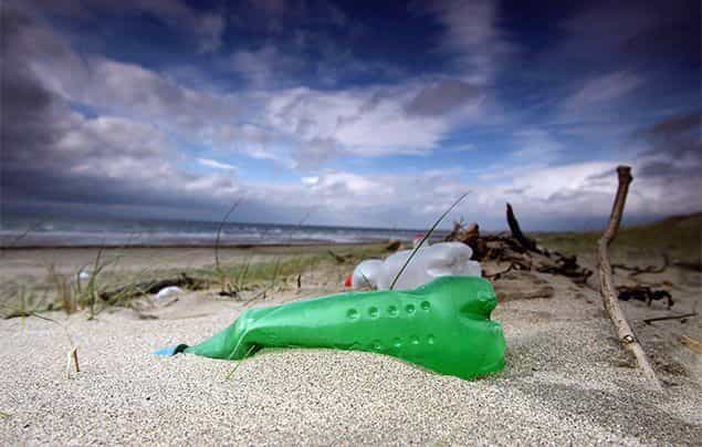 plastic bottles washed up on a stormy beach shore