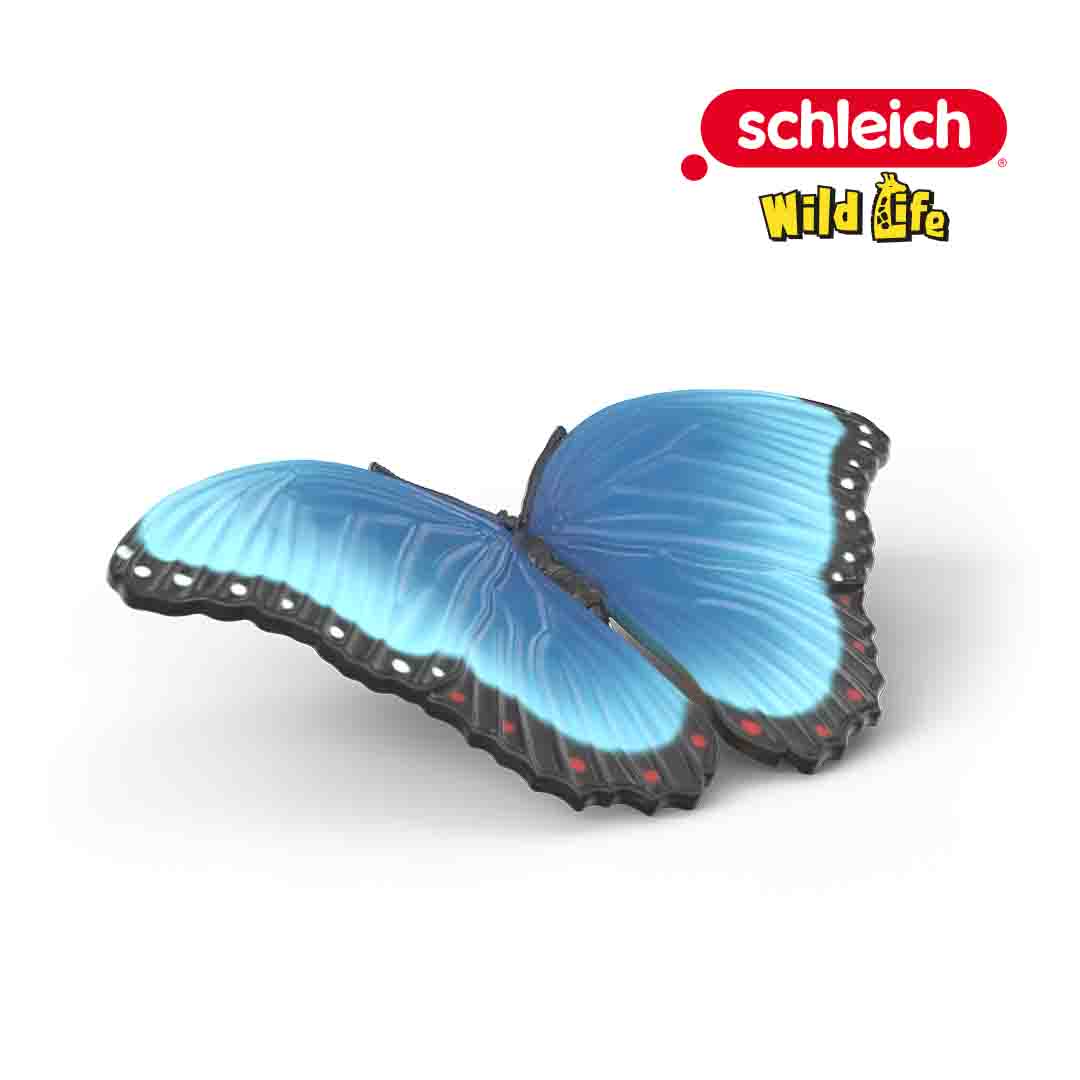 A blue butterfly figurine with black-edged wings and red spots, from the Schleich Wild Life collection Insects Discovery Set, displayed on a white background.